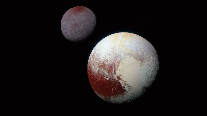 A NASA image of Pluto showing off its heart and its largest moon, Charon.