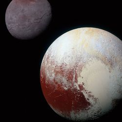 A NASA image of Pluto showing off its heart and its largest moon, Charon.
