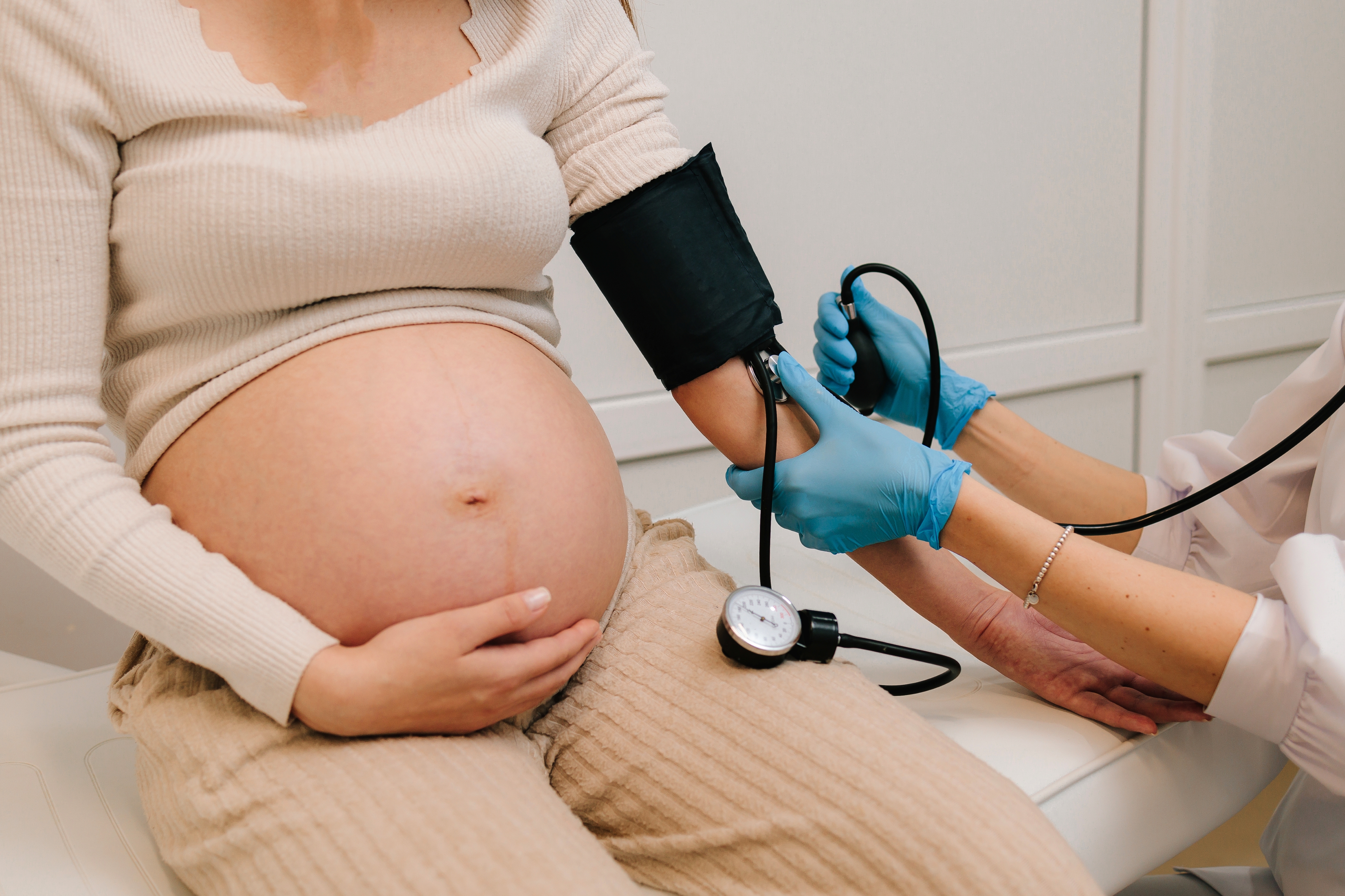 pregnant person having their blood pressure measured pregnant person having their blood pressure measured