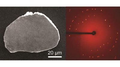 a grey slab and next to it a glowing red orb with bright dots representing the diffraction