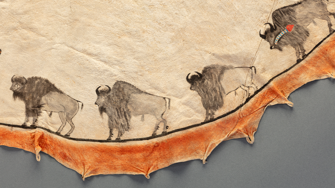 An incredible painted tipi wit four bison along the edge.