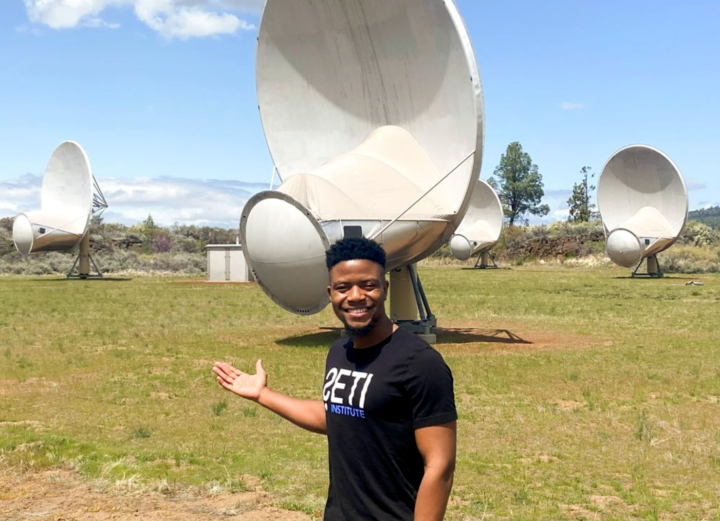 Ramiro Saide standing in front of four radio antennae